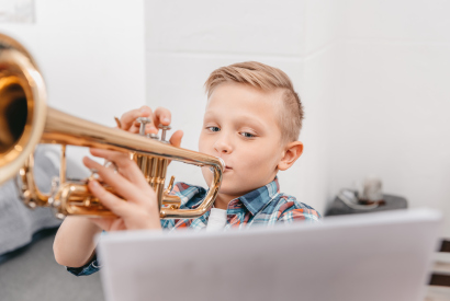Kind, das Trompete spielt